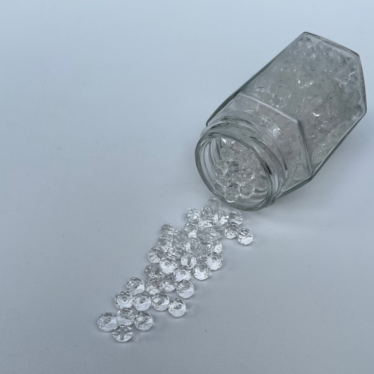 Glass jar with diamonds on a gray background