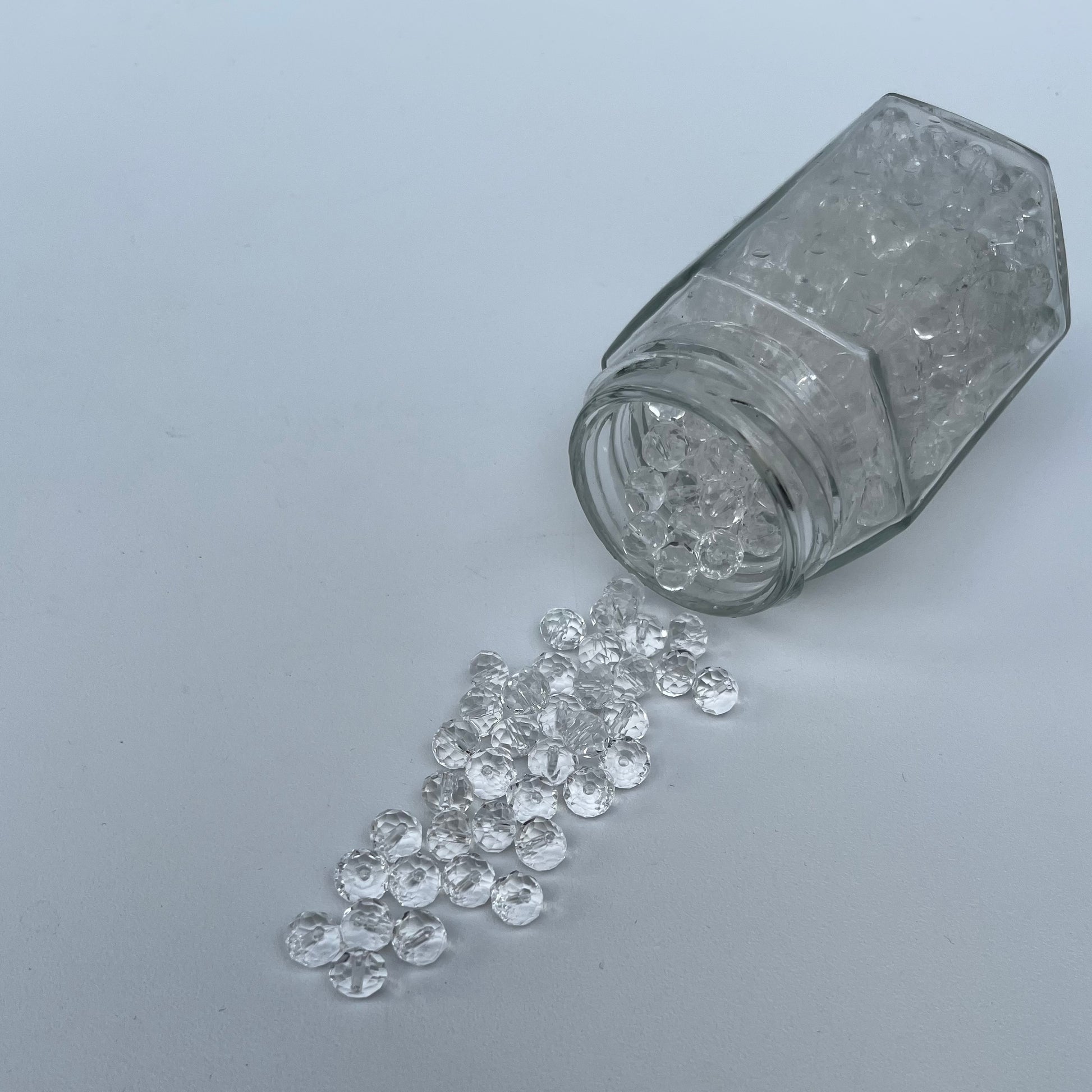 Glass jar with diamonds on a gray background