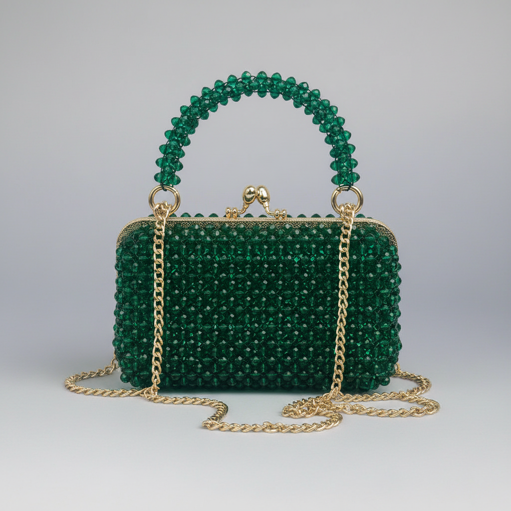 Green beaded handbag with gold chain on a light gray background