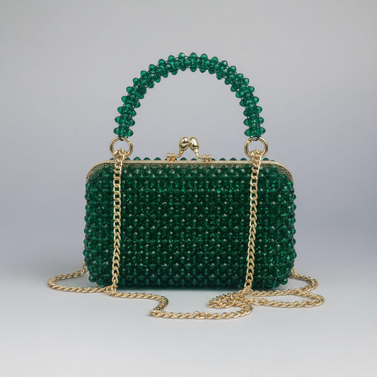 Green beaded handbag with gold chain on a light gray background