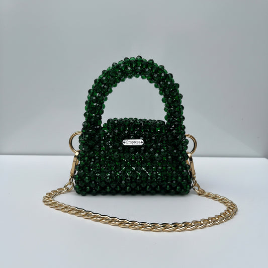 Green beaded bag with gold chain on a white background