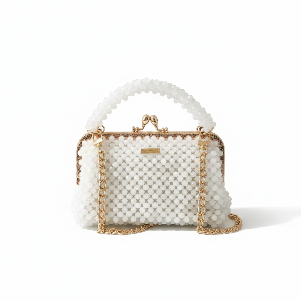 White textured handbag with gold chain strap on a white surface